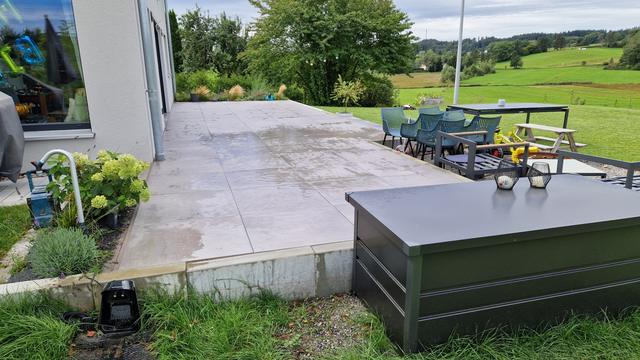 Plattenweg mit Natursteinmauer und Beeten